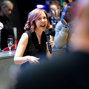 Woman holding mic at Innovate launch party